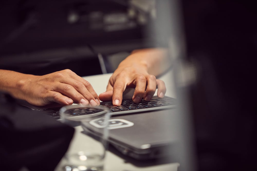 hands typing on keyboard